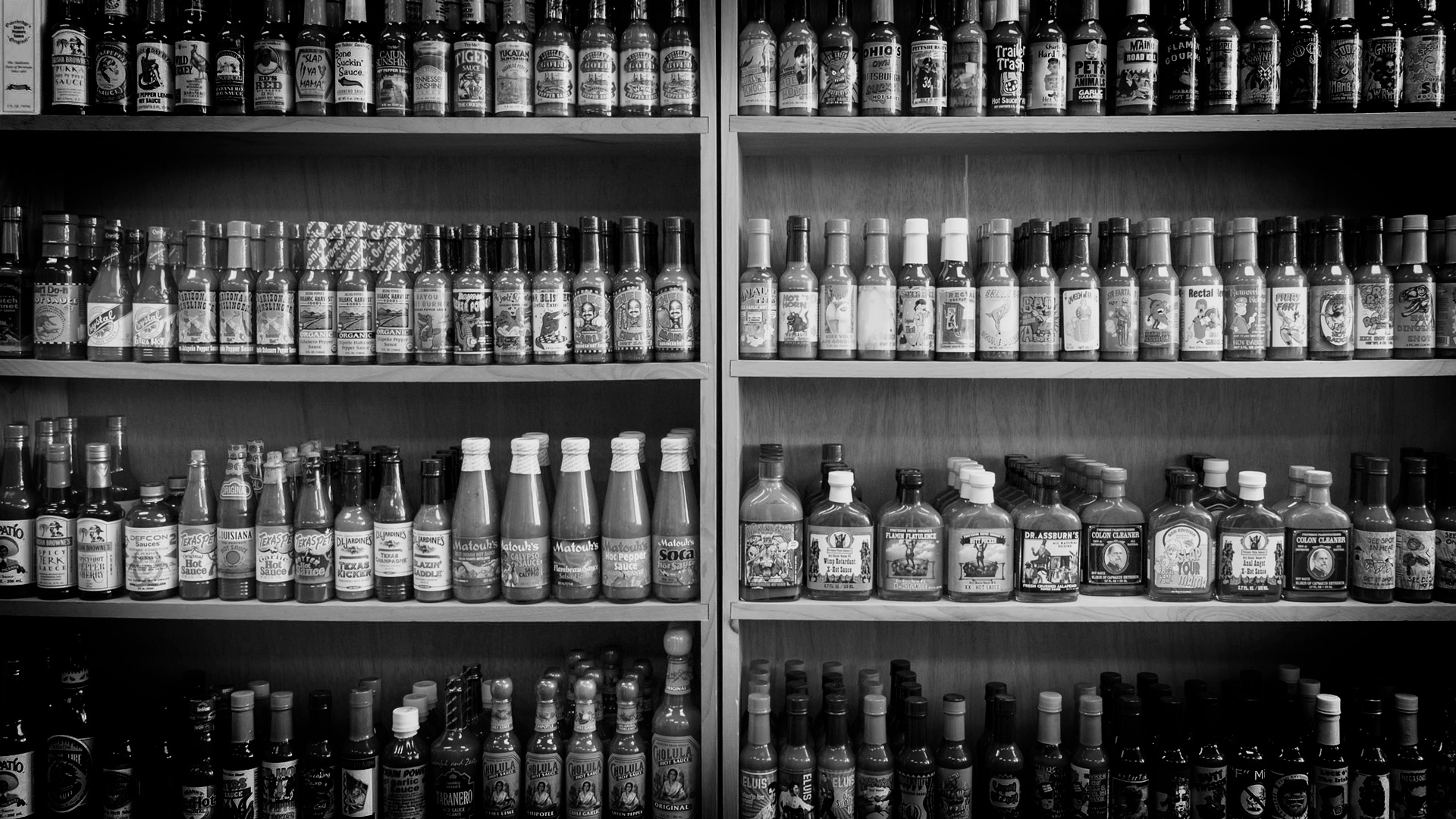 shelf full of hot sauces